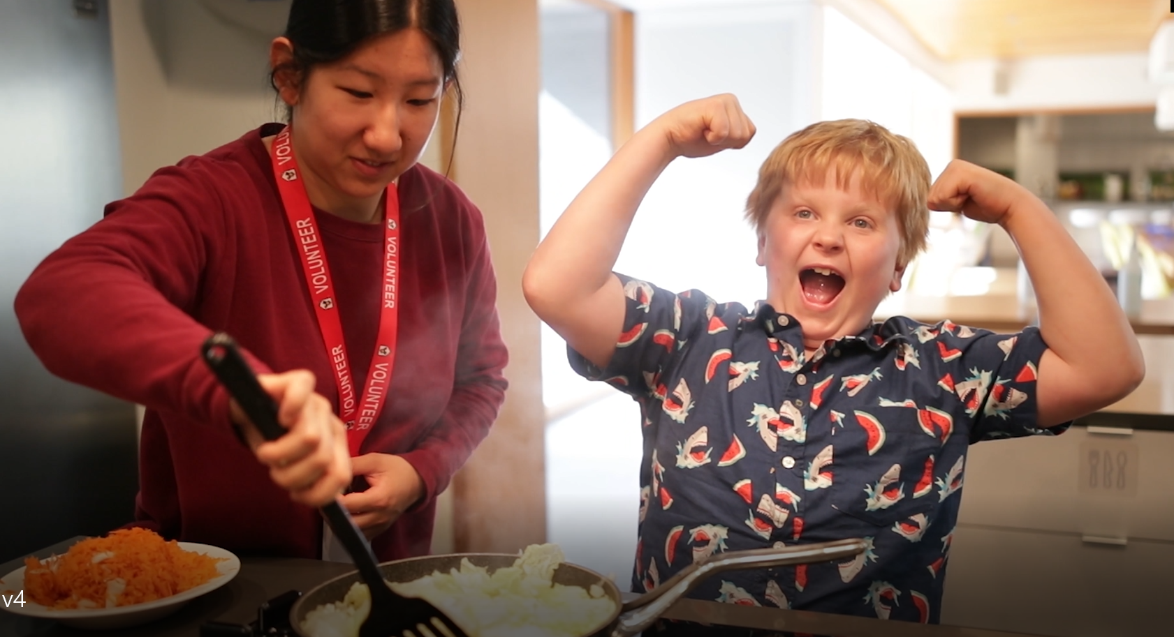 Volunteer and kid cooking