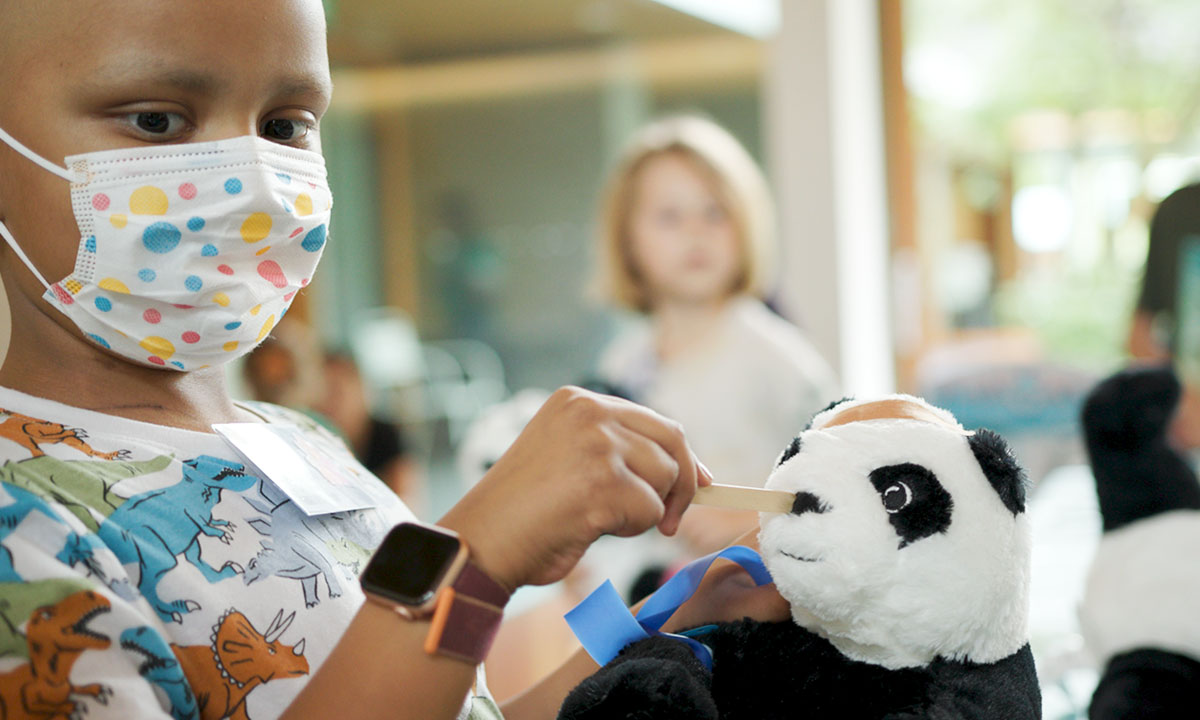 Child easing their fears through RMH BC Medical Play Program
